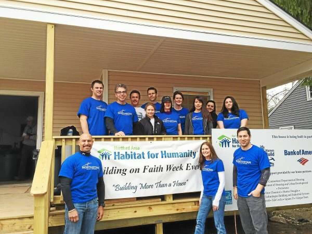 Contributed photo A group of 13 Northstar Wealth employees volunteered their time with Habitat for Humanity on a home in East Hartford.