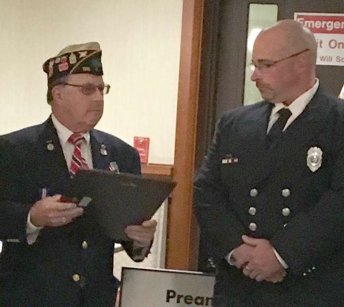 Post Commander Jeffrey Cole presents Firefighter Robert Howe III with the Firefighter of the Year award.