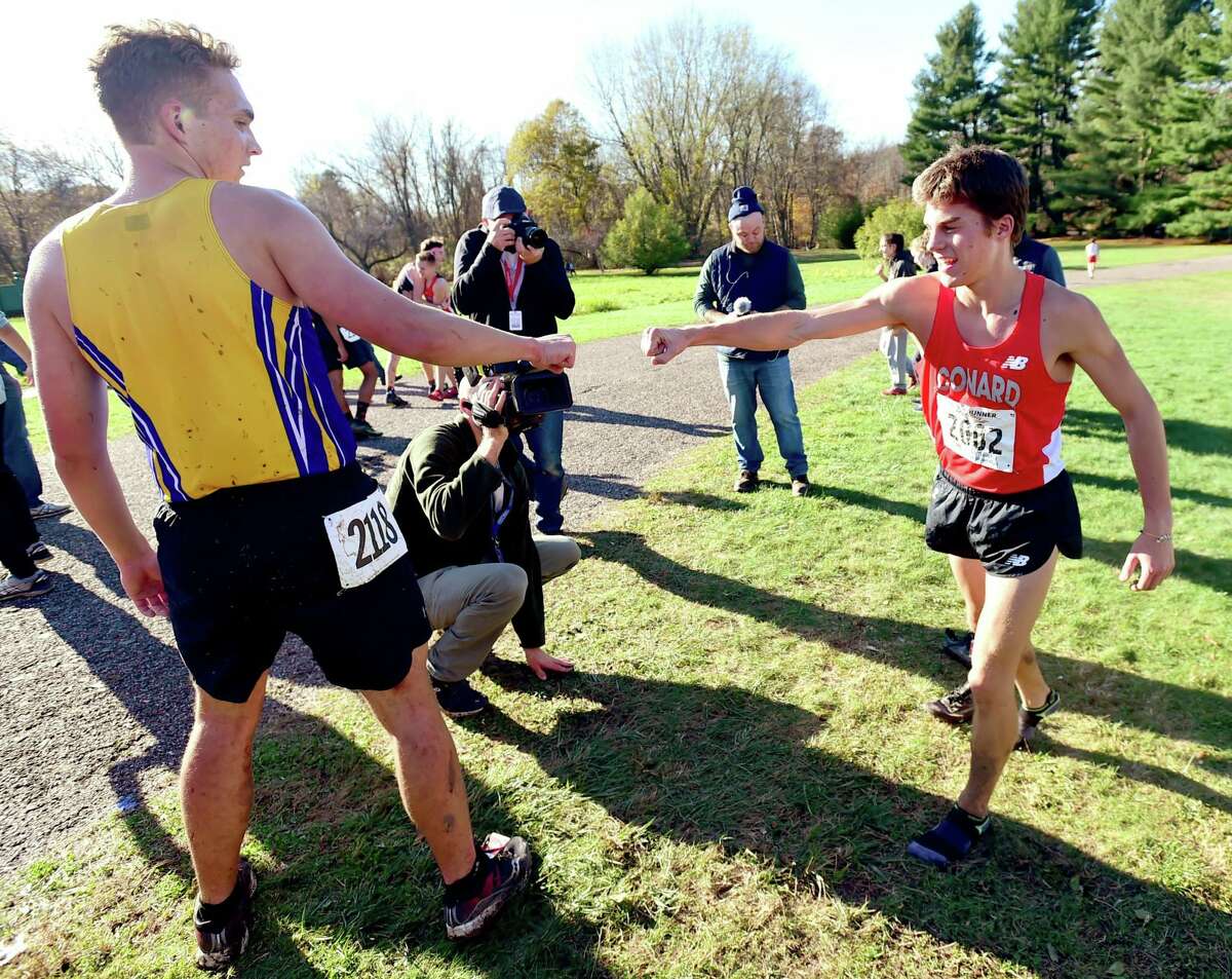 Conard’s Gavin Sherry, right, gives a fist pump to Simsbury’s Isaac Smith after Sherry won the State Open on Friday.