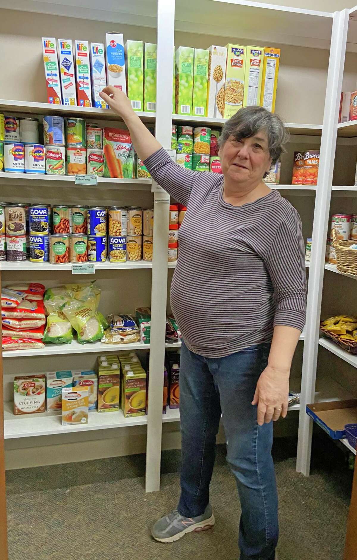 Bonnie Lasker volunteers to stock shelves with nutritious food for clients at the Anja Rosenberg Kosher Food Pantry at Jewish Family Services, 333 Bloomfield Ave., West Hartford.