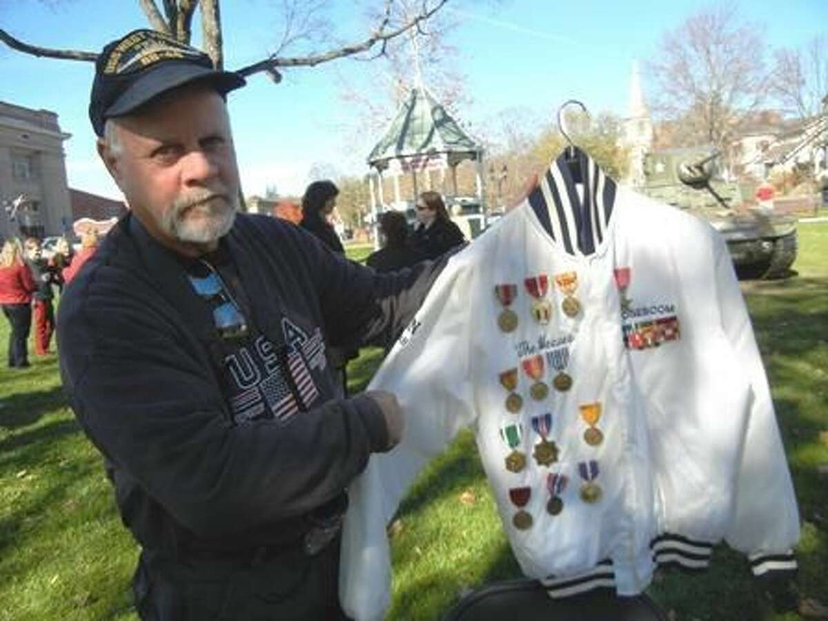 Bill Roseboom Jr. of Kent, holding a jacket made for his late father, who served on the USS West Virginia during World War II. Photo by Alice Tessier.