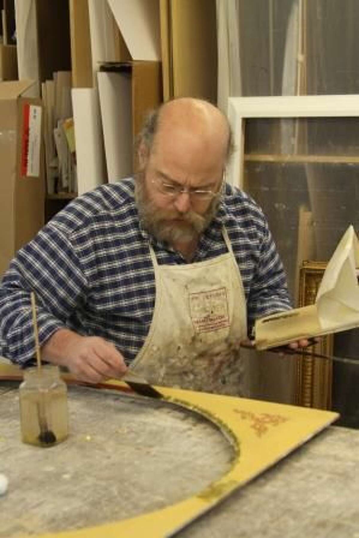 Artisan frame maker Peter Miller in his Woodbury studio. Photo by Kathryn Boughton/The Litchfield County Times.