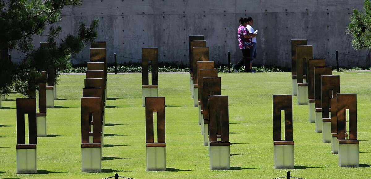 Visitors walk past artwork resembling chairs and depicting the lives that were lost from the 1995 bombing of the Alfred P. Murrah Building at the Oklahoma City National Memorial in Oklahoma City on May 23, 2012.