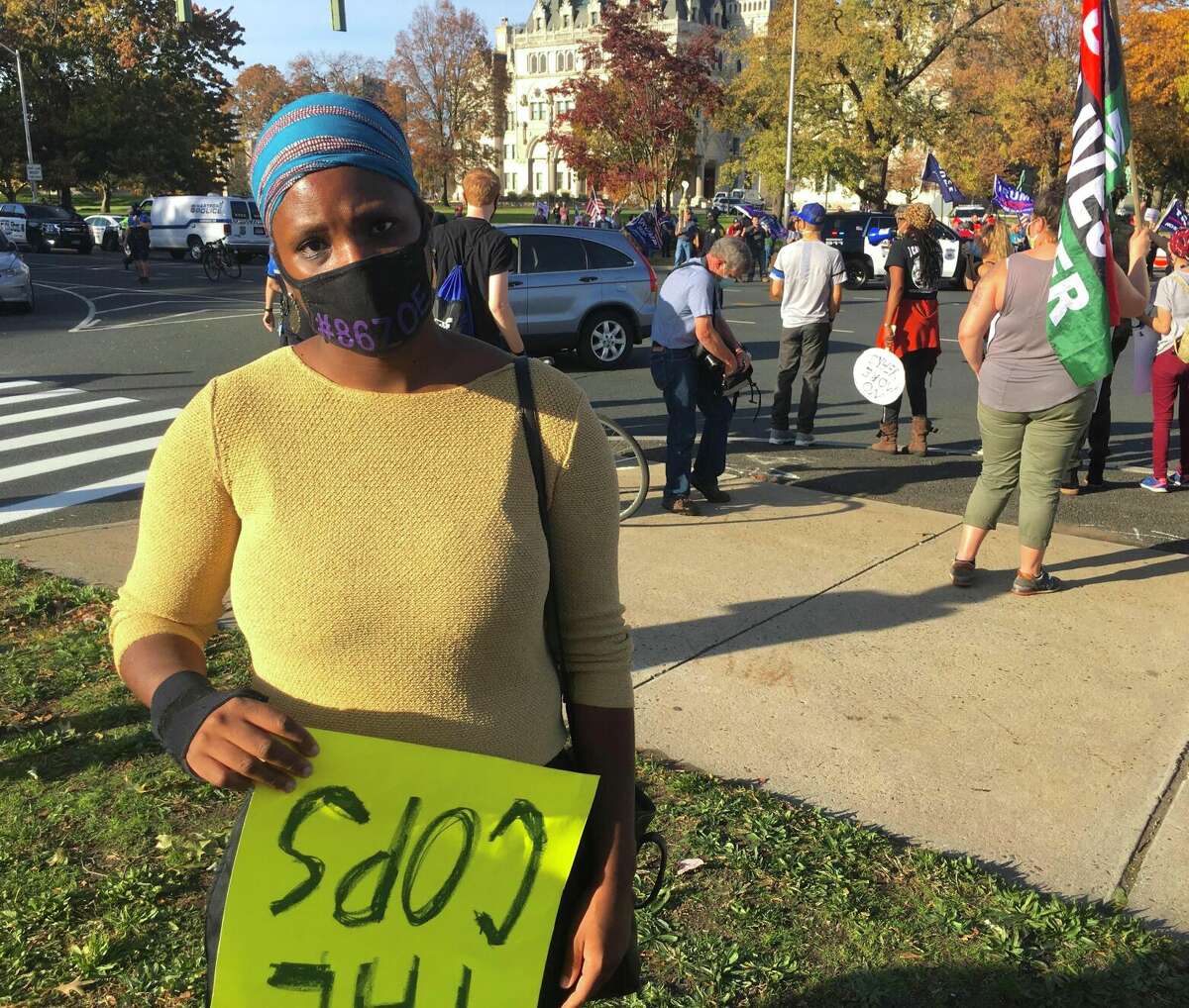 Tenaya Taylor, a Hartford activist for racial equity, attended a social justice rally in Hartford after Joe Biden was declared president-elect.  She carried a sign opposing police, drawing the ire of Trump supporters who held a rally in the same place.