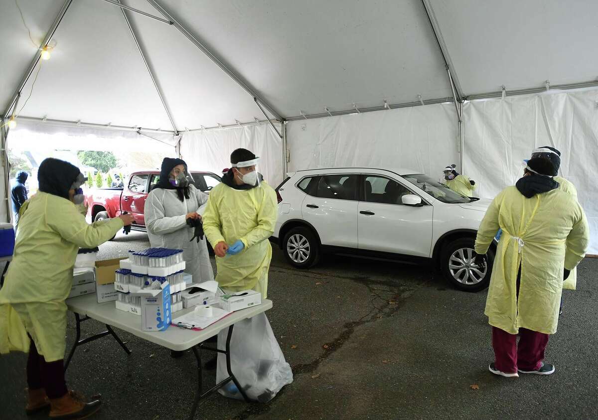Griffin Hospital employees administer free Covid-19 tests during the opening day of a drive through testing site at Unity Park in Trumbull, Conn. on Tuesday, December 8, 2020. Free testing will be available each Tuesday at the site from 9:30 am to 3 pm.