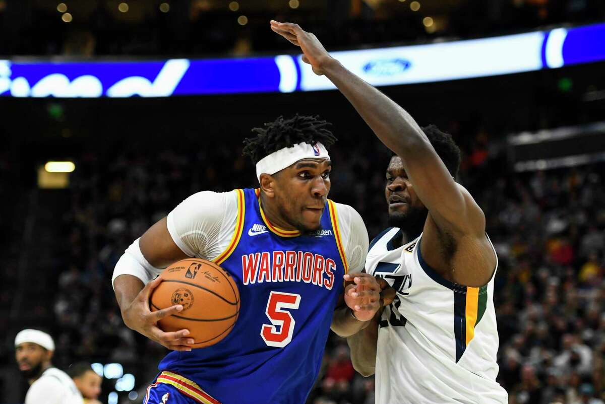 SALT LAKE CITY, UTAH - FEBRUARY 09: Kevon Looney #5 of the Golden State Warriors drives against Udoka Azubuike #20 of the Utah Jazz during the second half at Vivint Smart Home Arena on February 09, 2022 in Salt Lake City, Utah. NOTE TO USER: User expressly acknowledges and agrees that, by downloading and or using this photograph, User is consenting to the terms and conditions of the Getty Images License Agreement. (Photo by Alex Goodlett/Getty Images)
