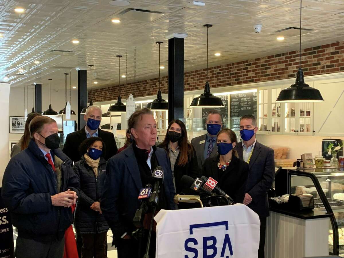 Gov. Ned Lamont speaks inside Arethusa Farm Dairy and Cafe about the importance of shopping local.