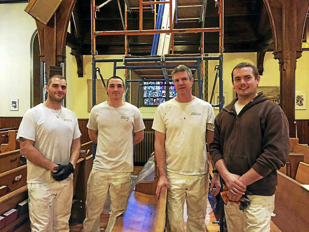 Contributed photo The crew from Stained Glass Resources of Hampden, Massachusetts — identified as Chad, Joe, Wade and Jared — work on Trinity Episcopal Church in Torrington.