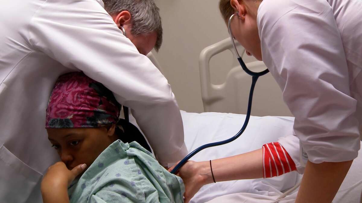A doctor and intern tend to a patient in the film.