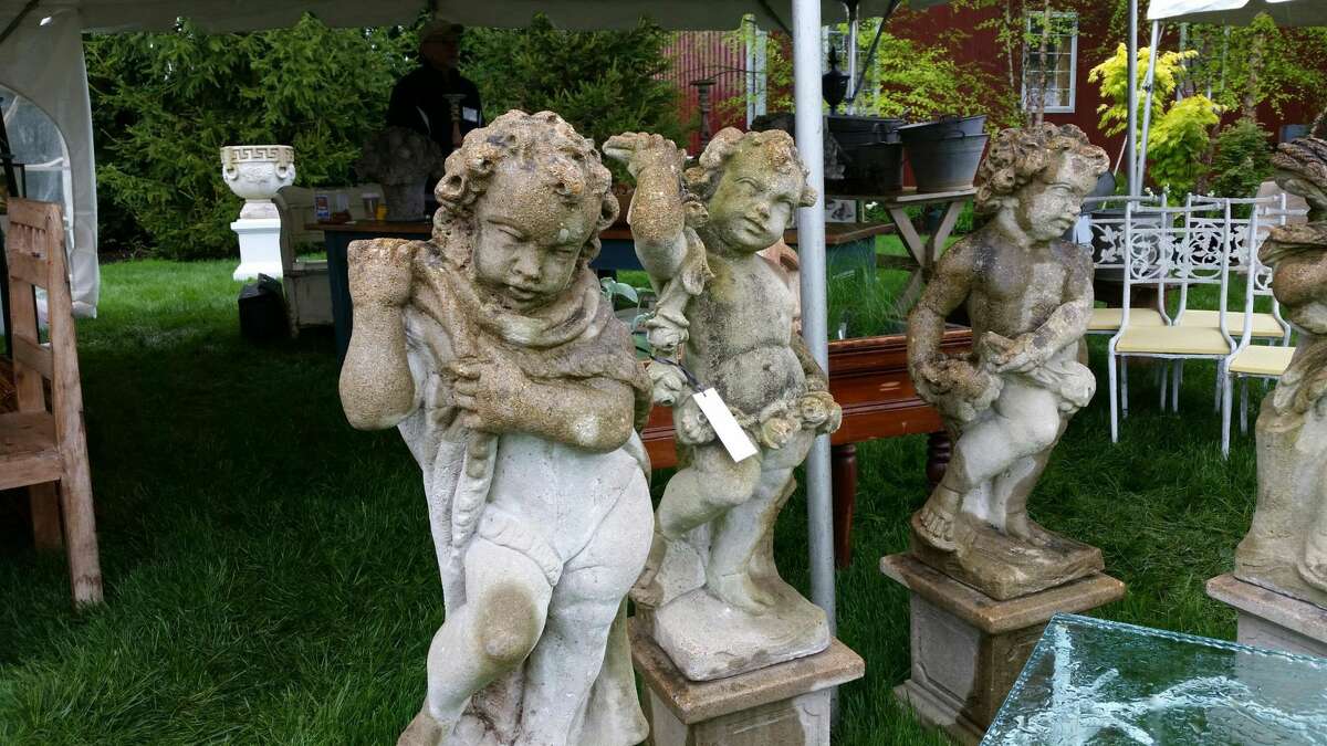 Stone garden cherubs stood outside the tent for Pillars Antiques of Freeport, Maine, one of 60 vendors this year at the 18th annual Trade Secrets Rare Plant and Garden Antiques Sale held at LionRock Farm, a 600-acre farm at 30 Hosier Road in Sharon.
