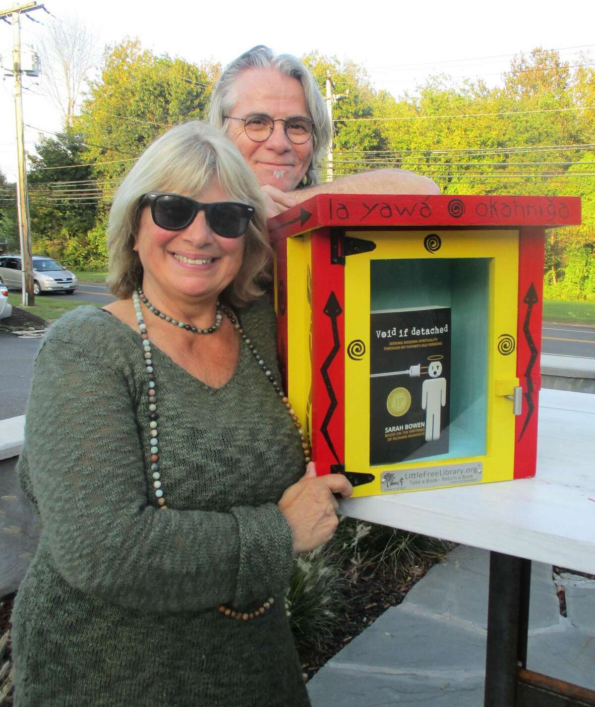 Rose Buckens and Sean Bowen with the little free library destined for installation at the Institute for American Indian Studies Museum.