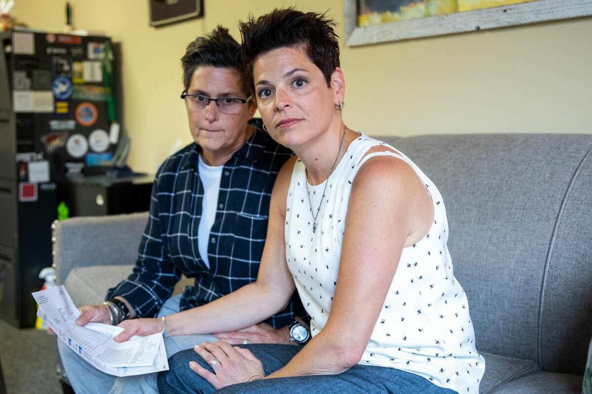 Joan Goldstein, right, 49, and her wife Lauren, left, 55, look through the line items of their medical bill. After contracting a virus that caused Lauren to fall ill, her wife rushed her to the emergency room where they stayed for several hours.