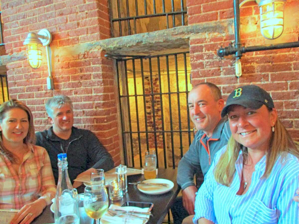 John and Nicole Acerbi, right, with friends Micah Richard and Sabrina Roper, all from Litchfield, met up in the cozy tavern, which features all the offerings from the Litchfield Distillery.