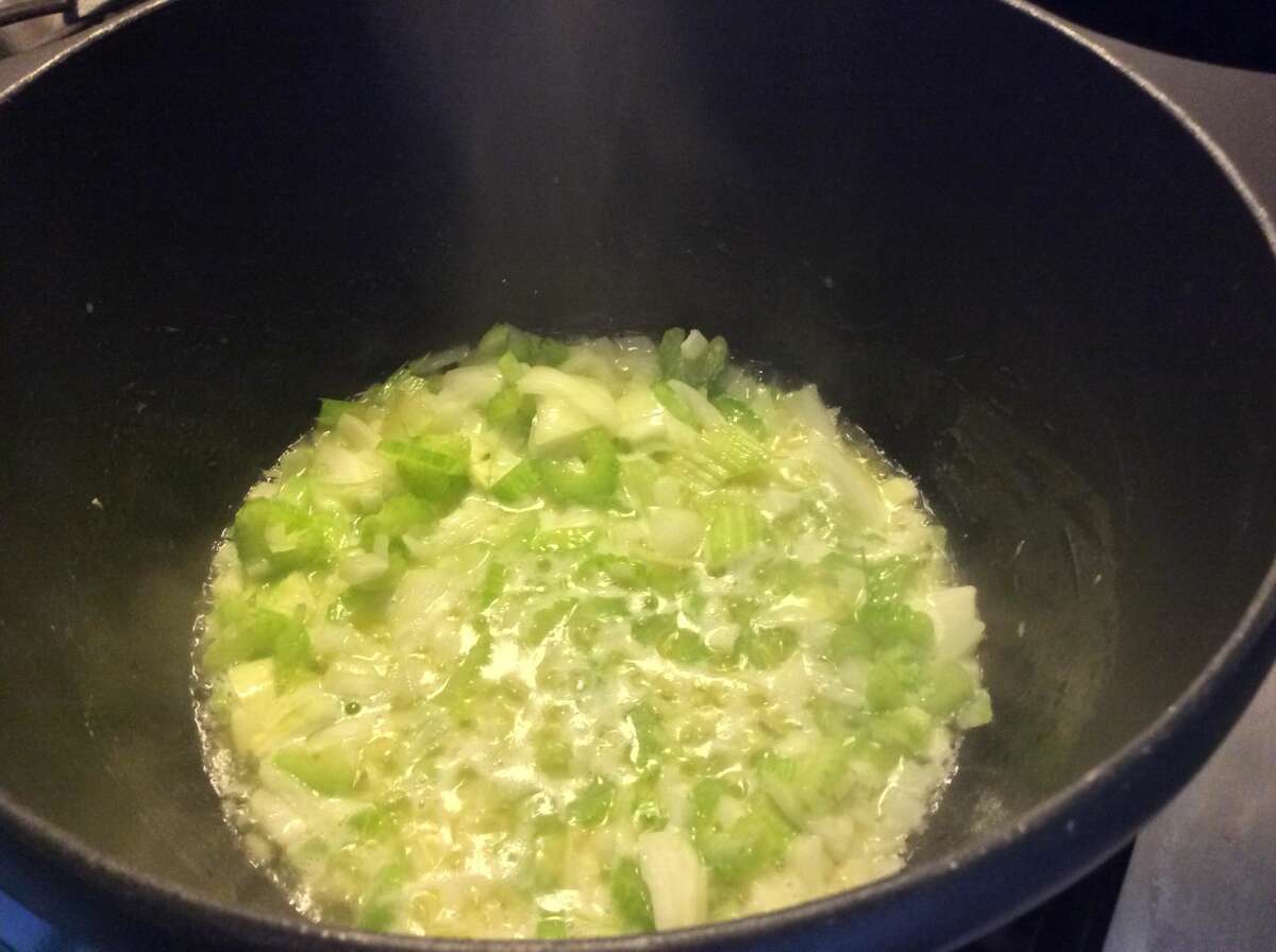 The onions and celery are sauteed in the butter.
