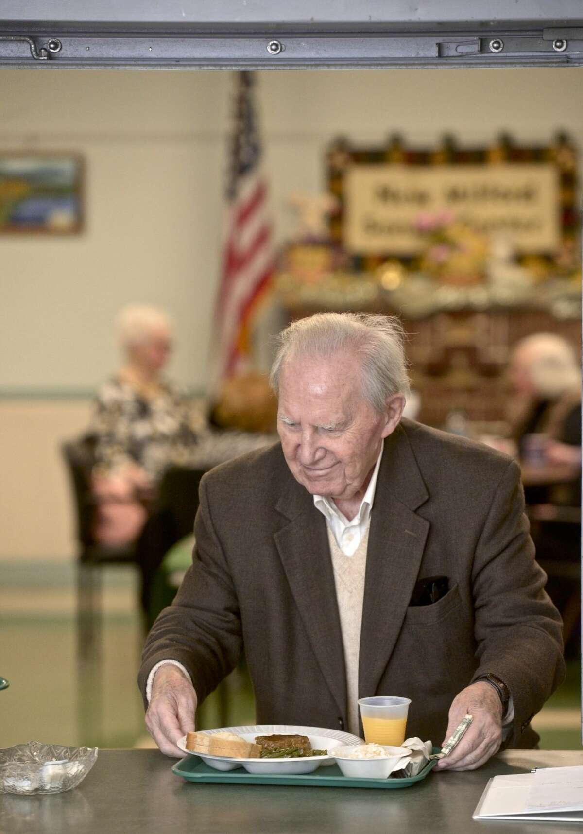 Peter Hill, of New Milford, picks up his lunch at the Senior Center in New Milford. The center and the Community Culinary School of Northwestern Connecticut have teamed up to offer locally made meals to seniors.