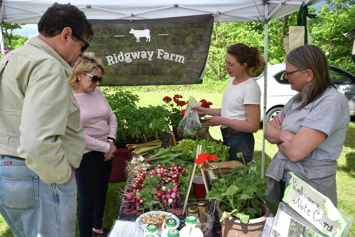 One of the farms participating in the Kent Farmer's Market is Ridgeway Farms, here selling radishes, greens and other items.