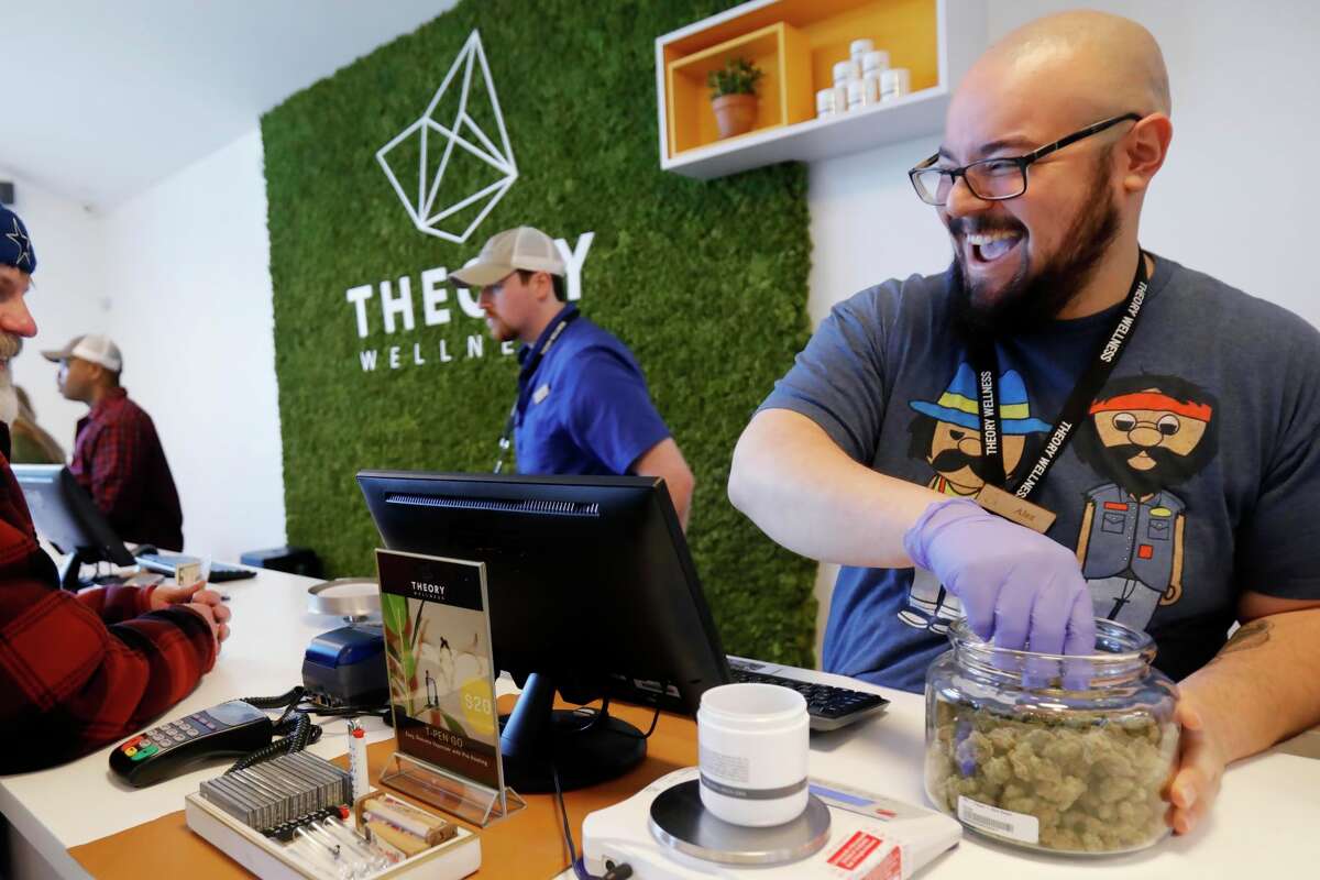 Alex Premoli makes the first sale to a customer on the opening day of recreational marijuana sales at Theory Wellness in Great Barrington, Mass., Friday, January 11, 2019. Theory is the first dispensary in the Berkshires to open its doors for recreational marijuana sales and the opening makes Theory the 6th dispensary of its kind in the state. (Stephanie Zollshan/The Berkshire Eagle )