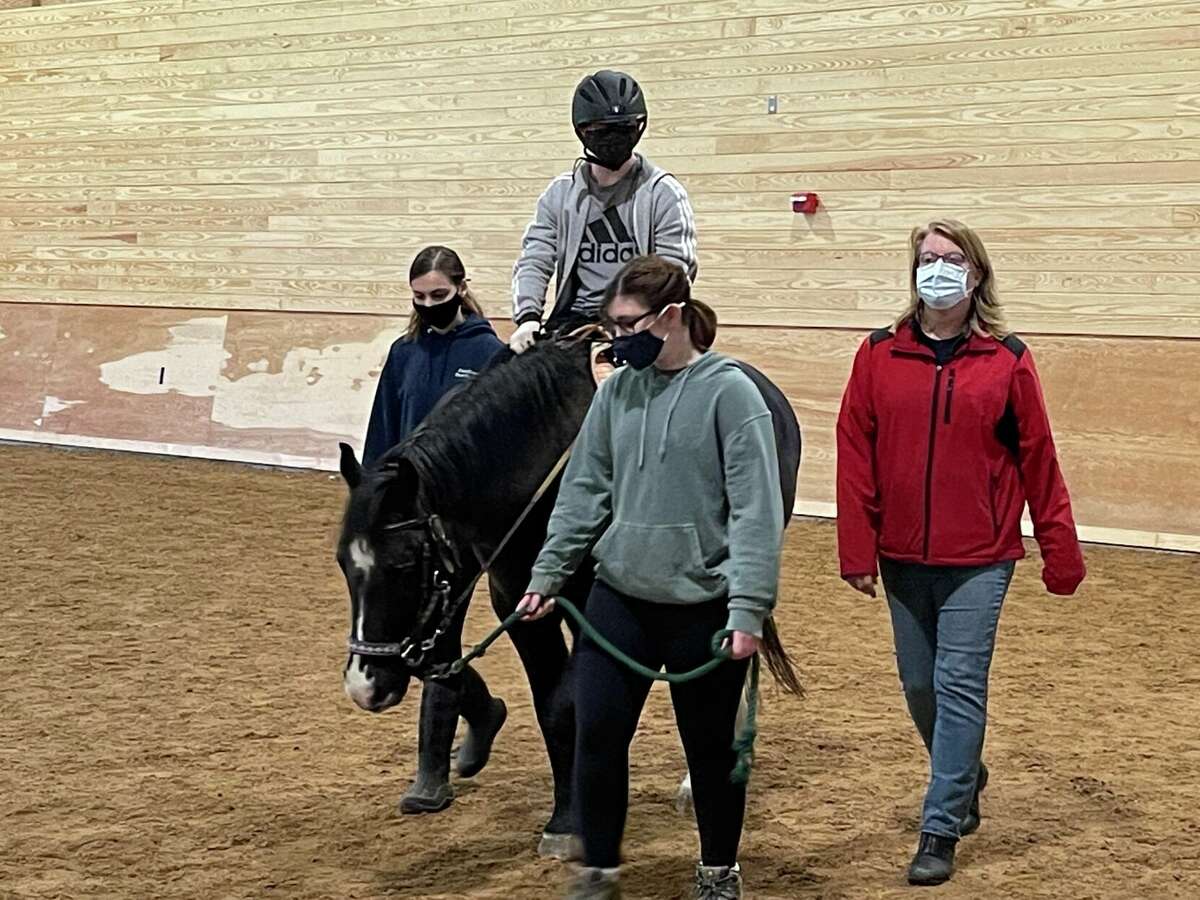 Gianna Campbell (Shepaug student volunteer), rider, Sophie Glickman (Shepaug student volunteer), Alice Daly. Rider is on Taz.