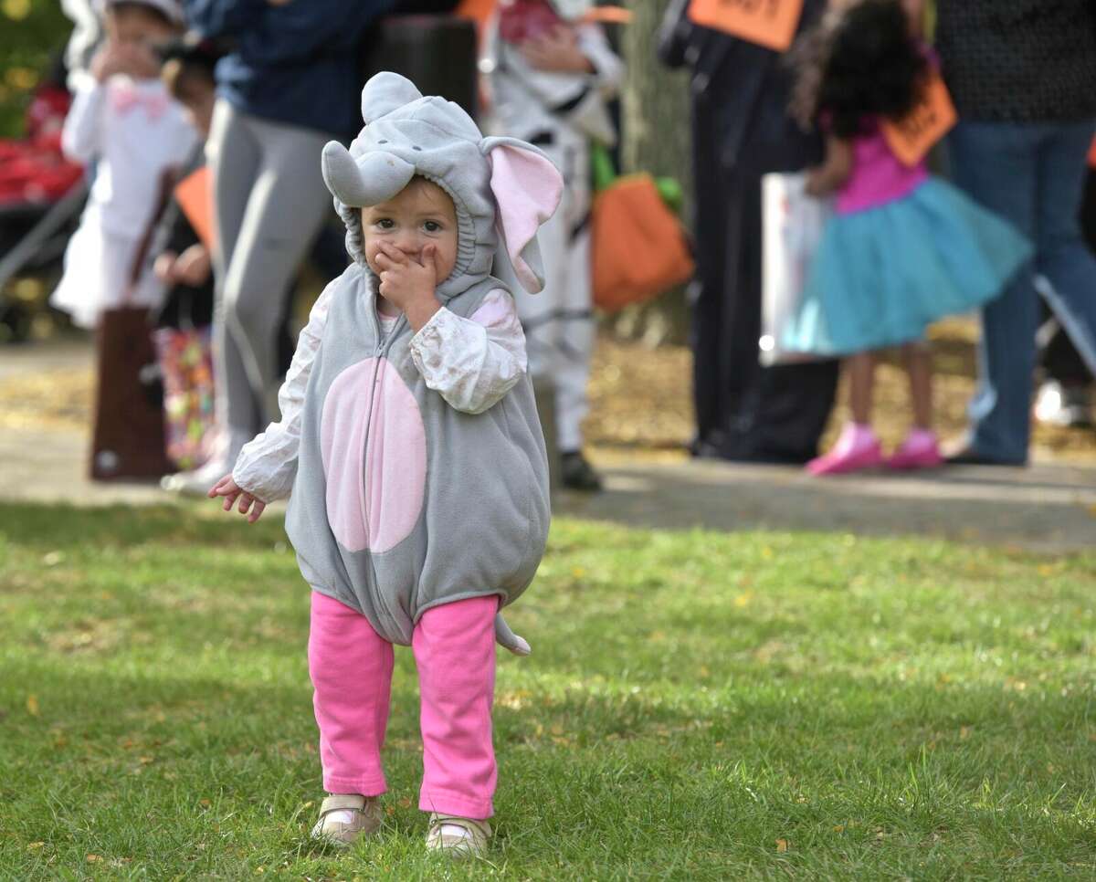 Baby elephant Adalyn Wilson, 1 1/2, of Sandy Hook, got a head start eating her Halloween candy at the 25th Halloween on the Green, sponsored by the Kiwanis of Danbury, Danbury Jaycees and CityCenter Danbury. Saturday, October 29, 2017, in Danbury, Conn. The city will host Halloween on the Green on Oct. 30, 2021.