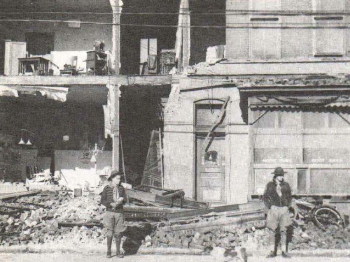 The erratic force of the 1938 tornado tore the front off this barbershop in North Alton. Boy Scout volunteers stood guard. Althoughthere were no deaths, the storm cut a five-mile path through a three-block wide portion of North Alton. The storm reportedly sweptup from the river at Hop Hollow and damaged forty structures.