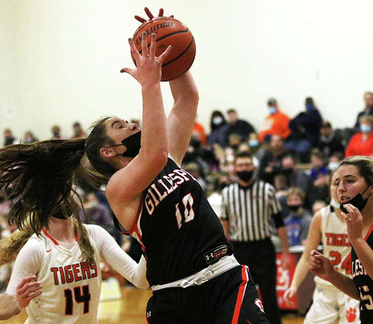 Gillespie's Madison Niemeyer (10), shown pulling down a rebound in a game against Greenfield at the Carlinville Tourney, scored 10 points on Wednesday in a loss to the host Cavaliers at Carlinville.