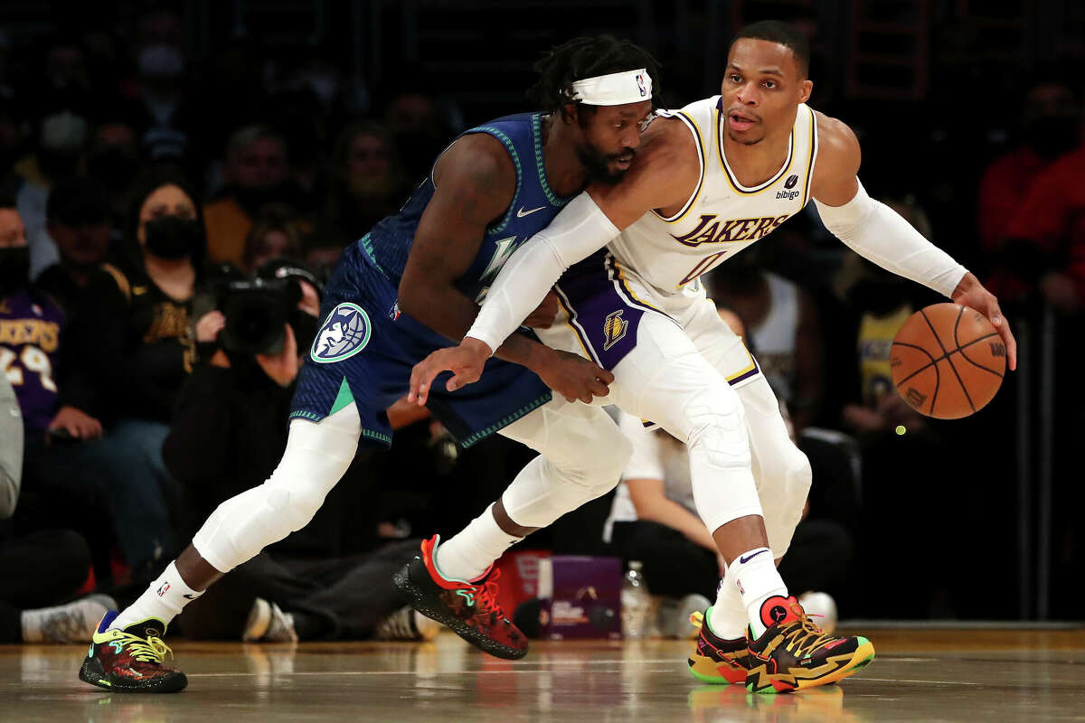 Russell Westbrook of the Los Angeles Lakers handles the ball against Patrick Beverley of the Minnesota Timberwolves during the first quarter at Crypto.com Arena on January 02, 2022 in Los Angeles, California.