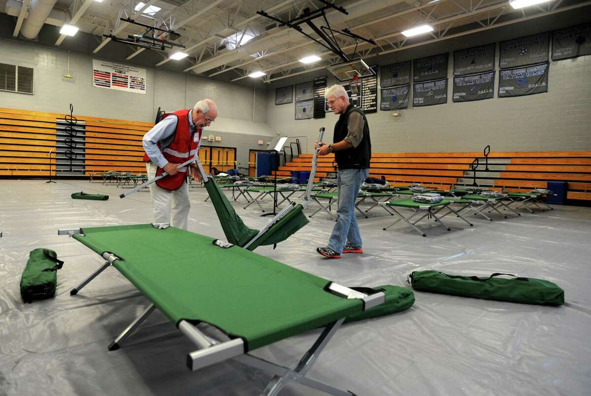 Former Fairfield resident, and former Fairfield Community Emergency Response Team volunteer Keene Harkrader, and Medical Reserve Corp volunteer, Ron Blumenfeld, also of Fairfield, previously set up beds at the emergency shelter at the Fairfield Ludlowe High School in Fairfield during Hurricane Sandy on Sunday, Oct. 28, 2012, prior to the Hurricane Sandy. The Fairfield Community Emergency Response Team is going to offer free disaster preparedness response training beginning Feb. 26, for five consecutive Saturdays, ending March 26, from 8 a.m. to 2 p.m., for each of the Saturdays.