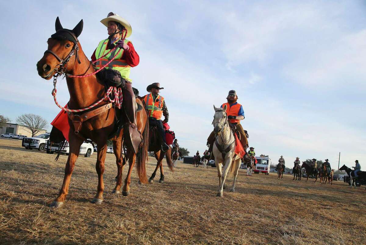 Point scouts Jenny Hauser, from left, William Golden and Coy Dunn head out as the South Texas Trail Riders make their way toward the San Antonio Stock Show & Rodeo from Floresville along U.S. 181 on Thursday, Feb. 10, 2022.