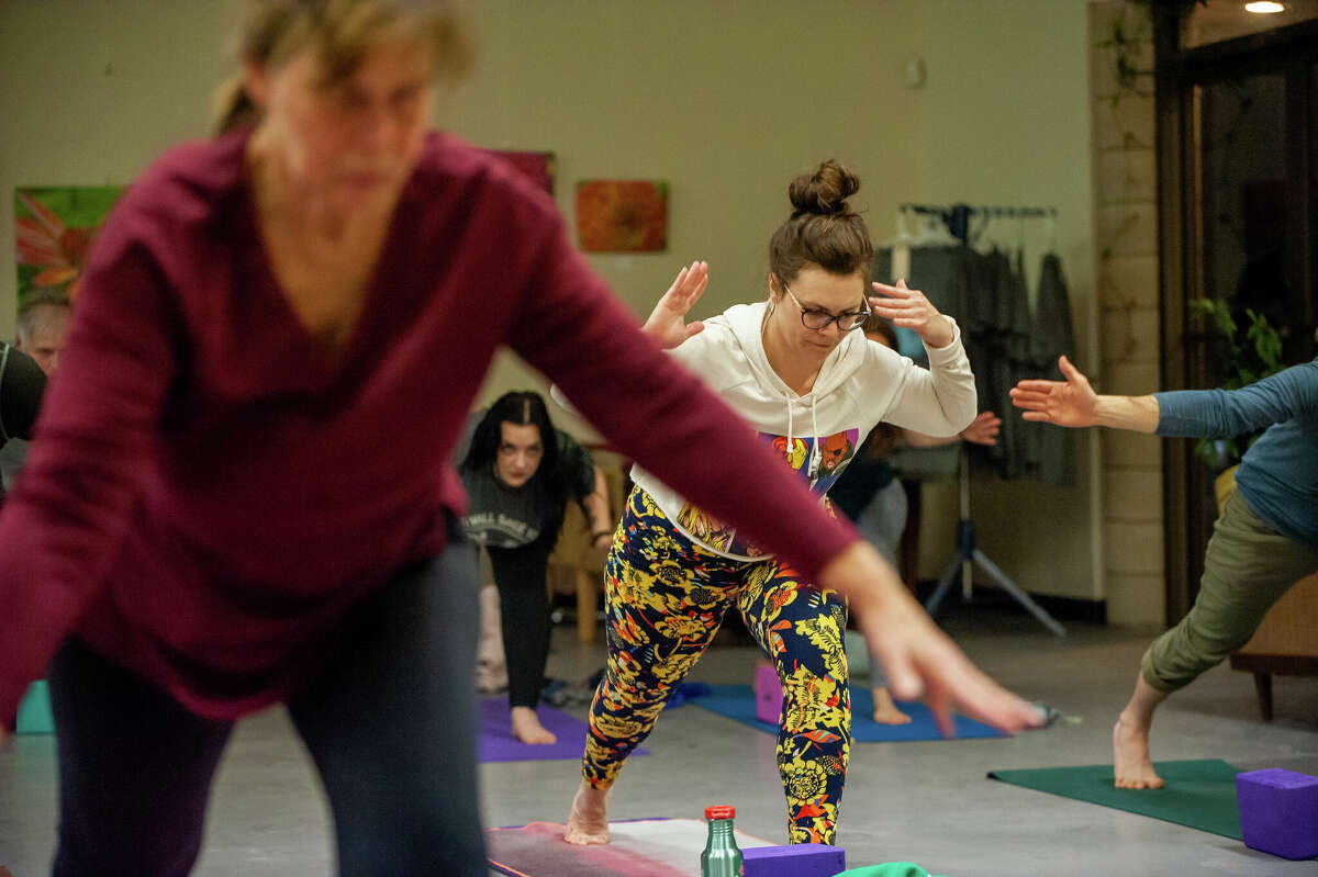 Hemlock resident (middle) Chelsea Wietfeldt practices yoga during the Happy Hour Yoga event on Feb. 9, 2022 at Mi Element Grains & Grounds. The event is held monthly at the micro brewery and coffee shop.