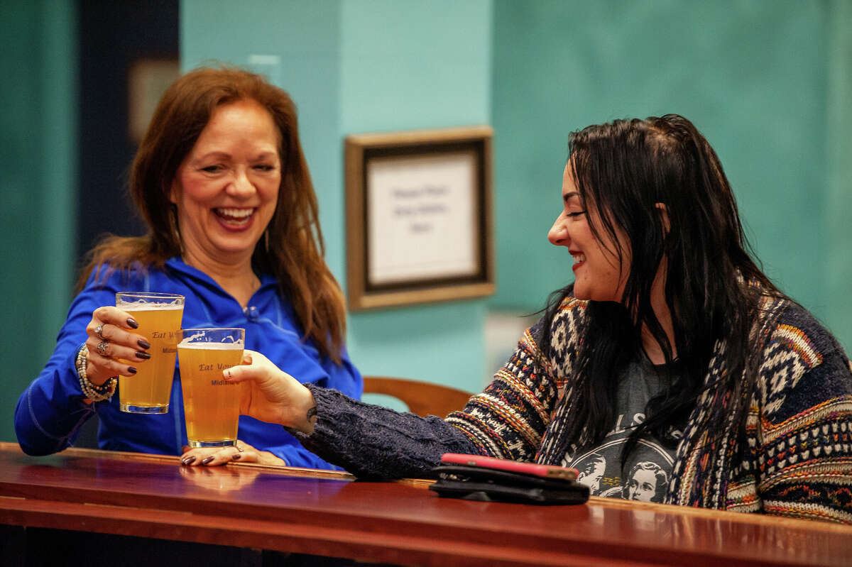 Jill Hoyle (left) and her daughter, Jacqui Hoyle, enjoy beer after a yoga session during the Happy Hour Yoga event on Feb. 9, 2022 at Mi Element Grains & Grounds. The event is held monthly at the micro brewery and coffee shop.