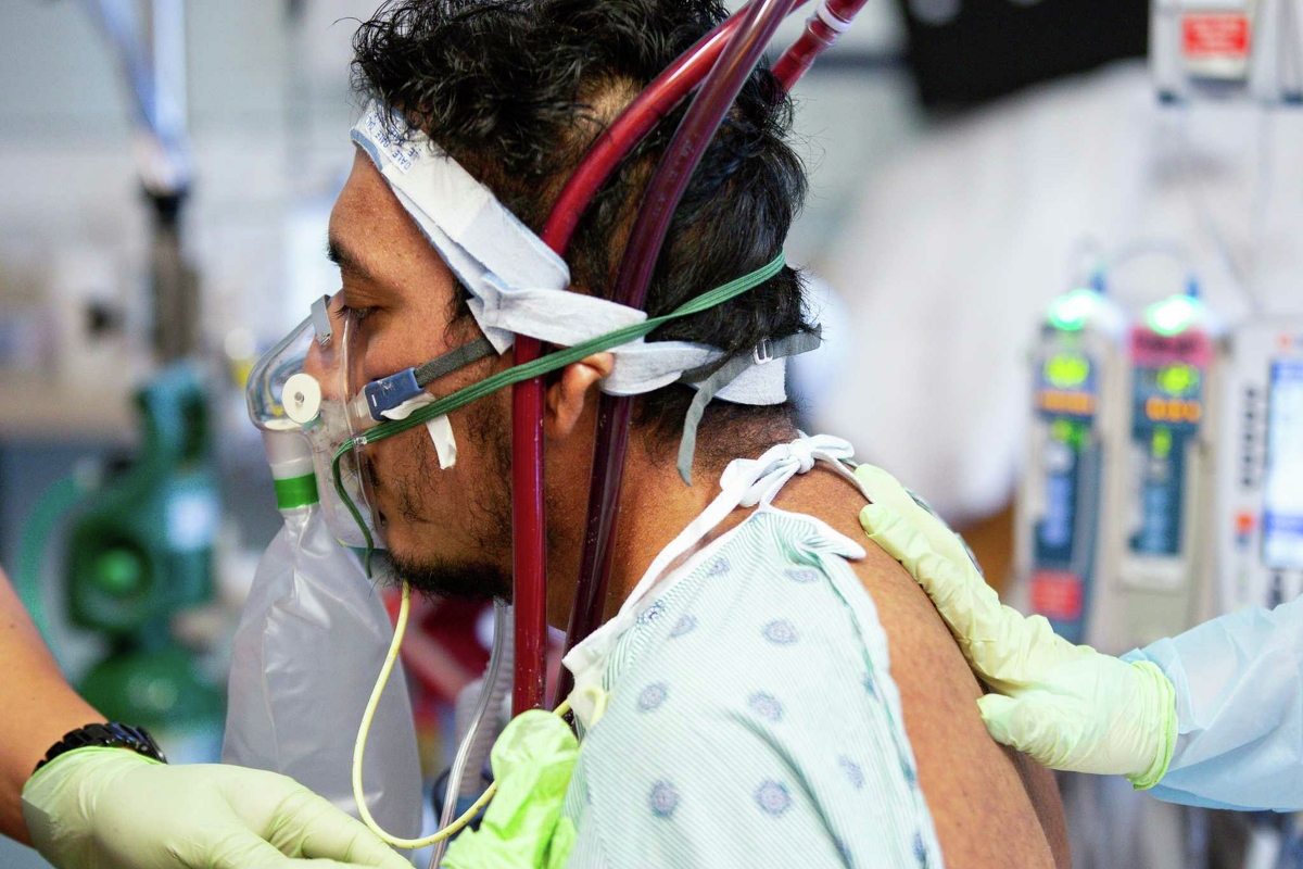 Jesus Ceja Ceja used an oxygen mask to catch his breath following a walking therapy session at Houston Methodist Hospital’s intensive care unit on Wednesday, Sept. 8, 2021, in Houston.