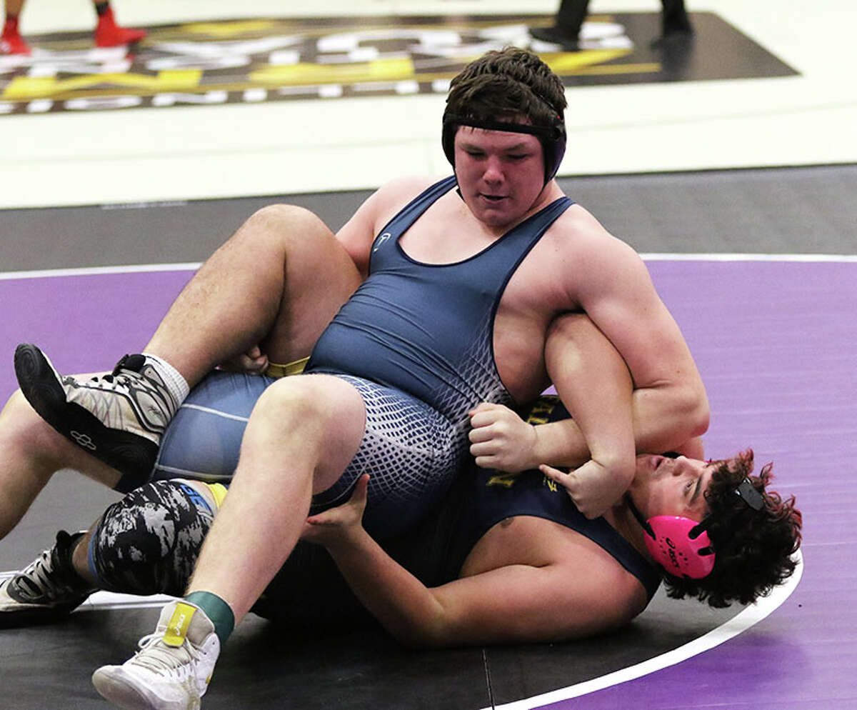 Jersey's Jaydon Busch (top), shown wrestling O'Fallon's Isaiah Hill in the 285-pound title bout at December's Mascoutah Tournament, goes to the Mahomet-Seymour Class 2A Sectional as a regional champion with a 27-6 record.