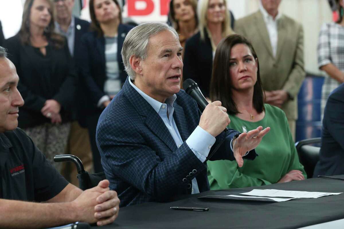 Texas Gov. Greg Abbott provides a statement after various business and trade organizations and pacts endorsed him during an event at Sunbelt Material Handling, Thursday, Feb. 10, 2022. With him are, left, George Munford with Sunbelt, and Annie Spillman, State Director at National Federation of Independent Business.