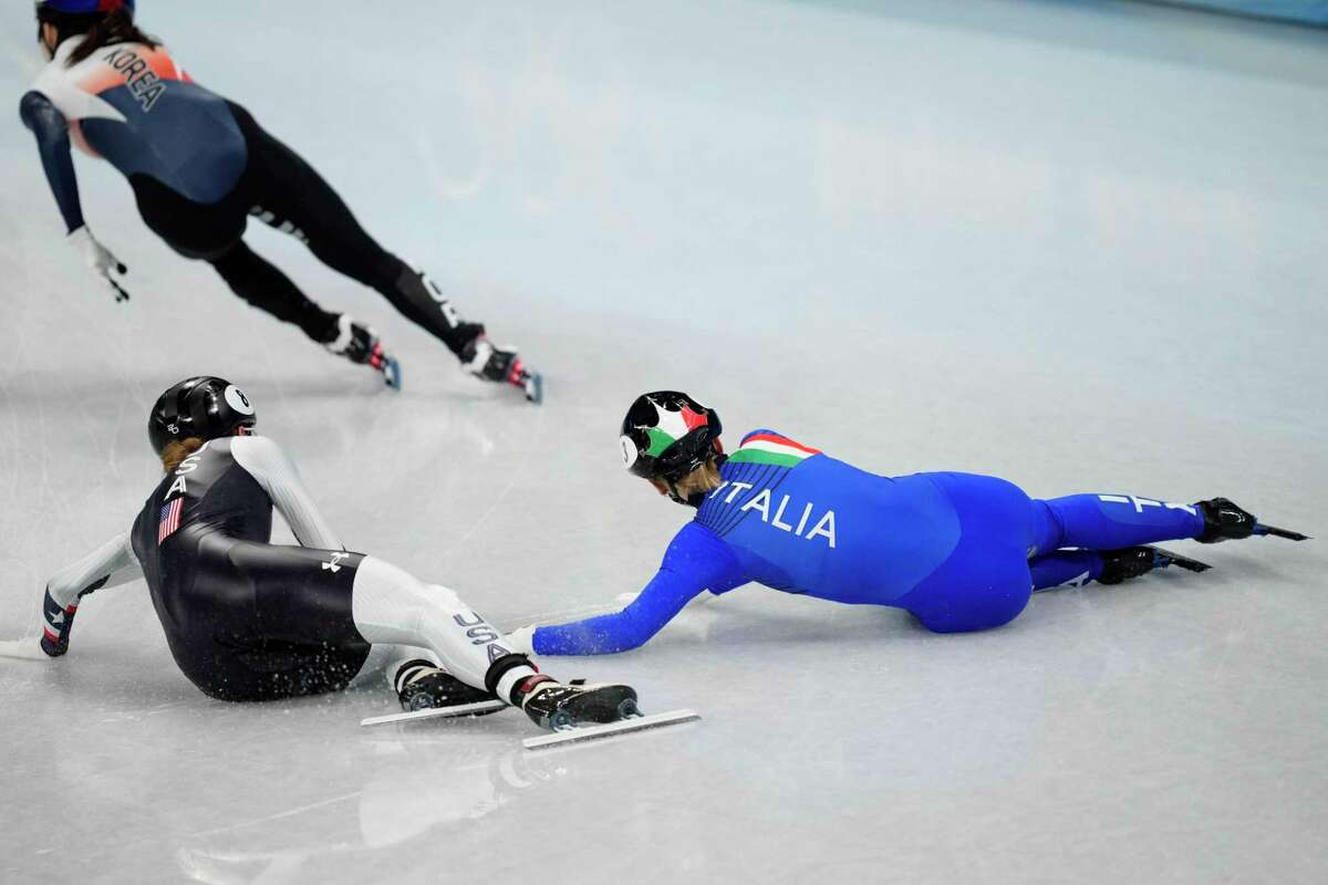 Kristen Santos of the United States, and Arianna Fontana of Italy, crash in the final of the women's 1000-meters during the short track speedskating competition at the 2022 Winter Olympics, Friday, Feb. 11, 2022, in Beijing. (AP Photo/Bernat Armangue)