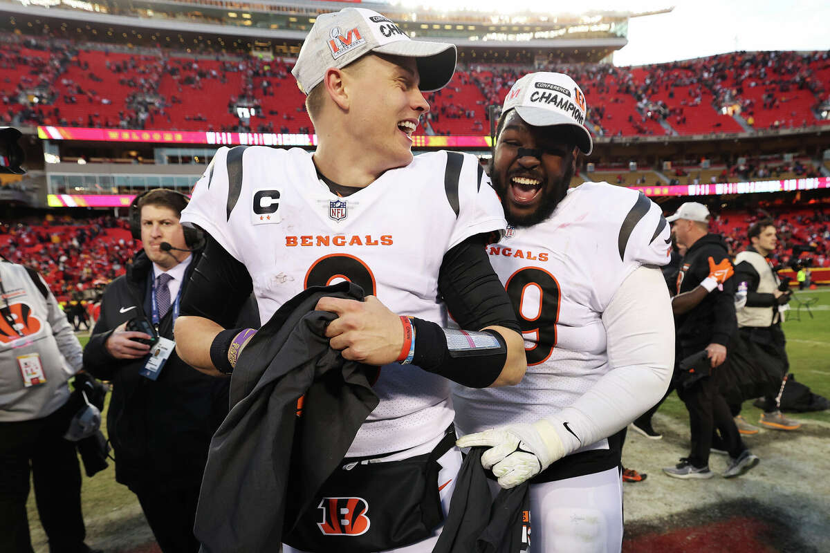 Joe Burrow of the Cincinnati Bengals celebrates the Bengals win over the Kansas City Chiefs with teammate Tyler Shelvin in the AFC Championship Game at Arrowhead Stadium on January 30, 2022 in Kansas City, Missouri.