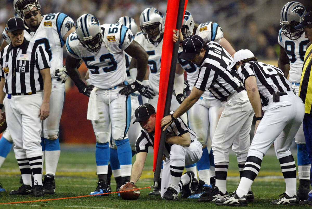 The officials measure to see if the Carolina Panthers have a first down against the New England Patriots during Super Bowl XXXVIII at Reliant Stadium on February 1, 2004 in Houston.