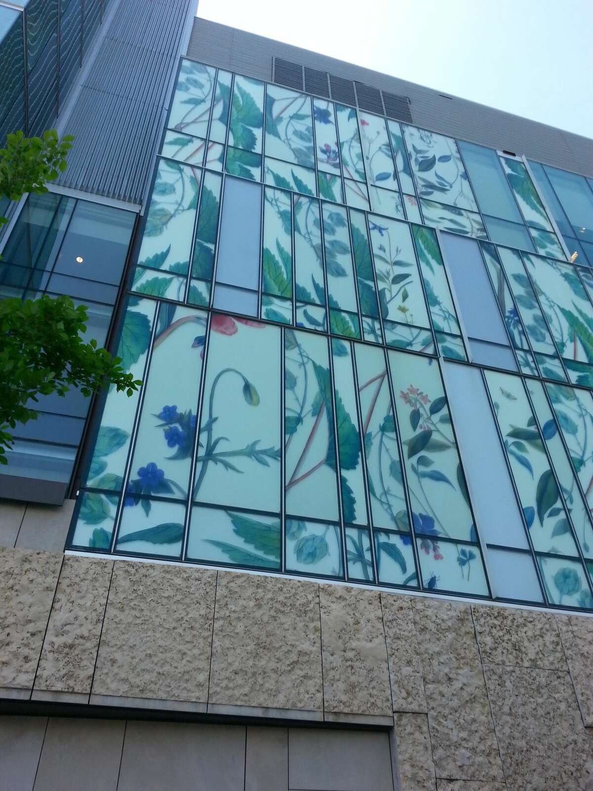This undated photo provided by American Bird Conservancy shows a bird-friendly design at the School of Pharmacy at the University of Waterloo that uses a variety of different materials in addition to glass, including panels depicting plants that are the sources of different drugs, in Ontario, Canada.