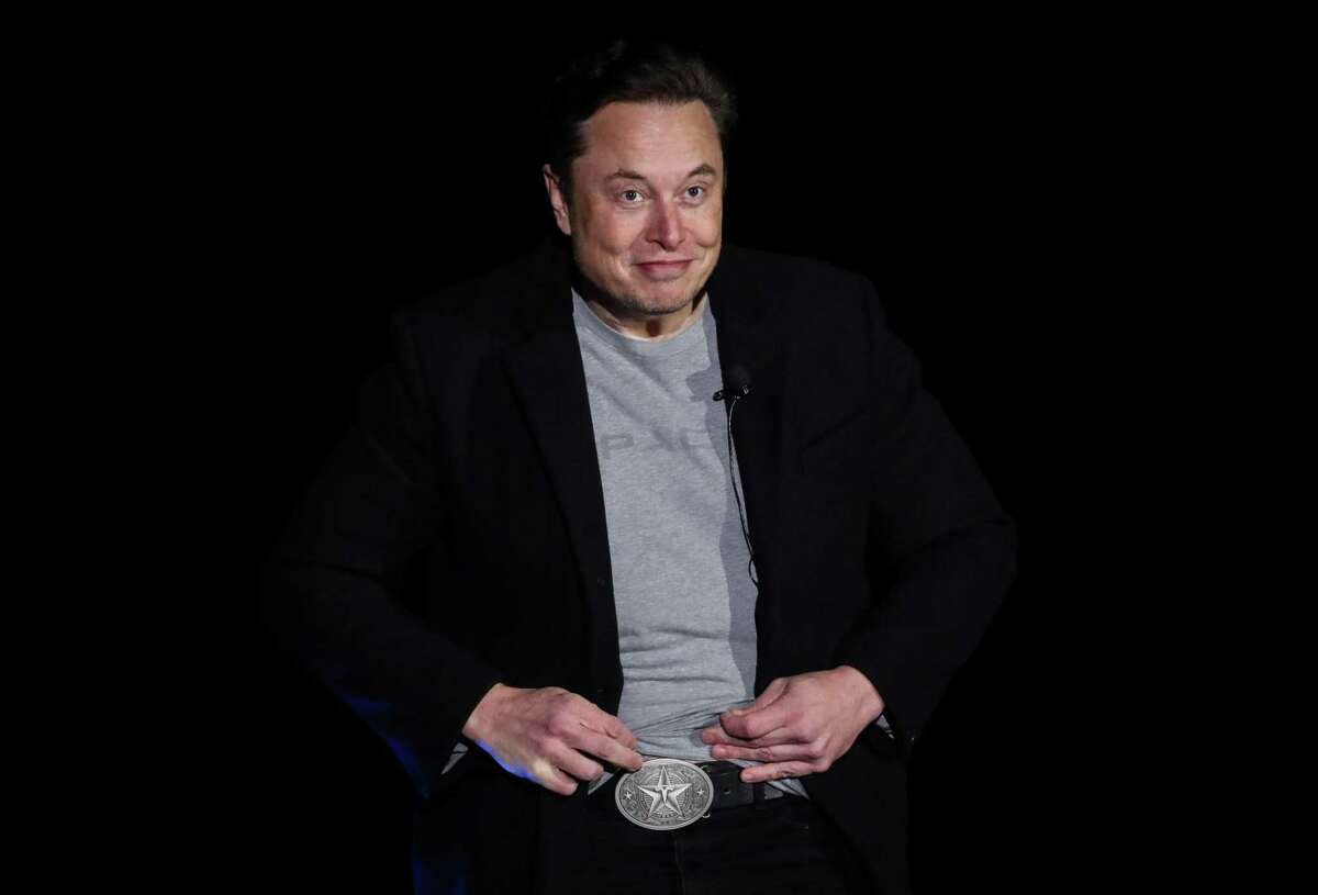 Elon Musk, founder of SpaceX, points to a Texas- and Tesla-themed belt buckle as he answers a question about operating his business in Texas during a Starship update press conference Thursday, Feb. 10, 2022, at a SpaceX facility in Boca Chica.