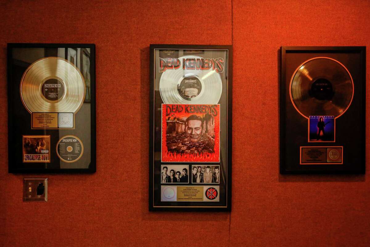 A gold record of Tupac Shakur (left), a platinum record of Dead Kennedys and a gold record of Joe Satriani hang on the wall at Hyde Street Studios in San Francisco.