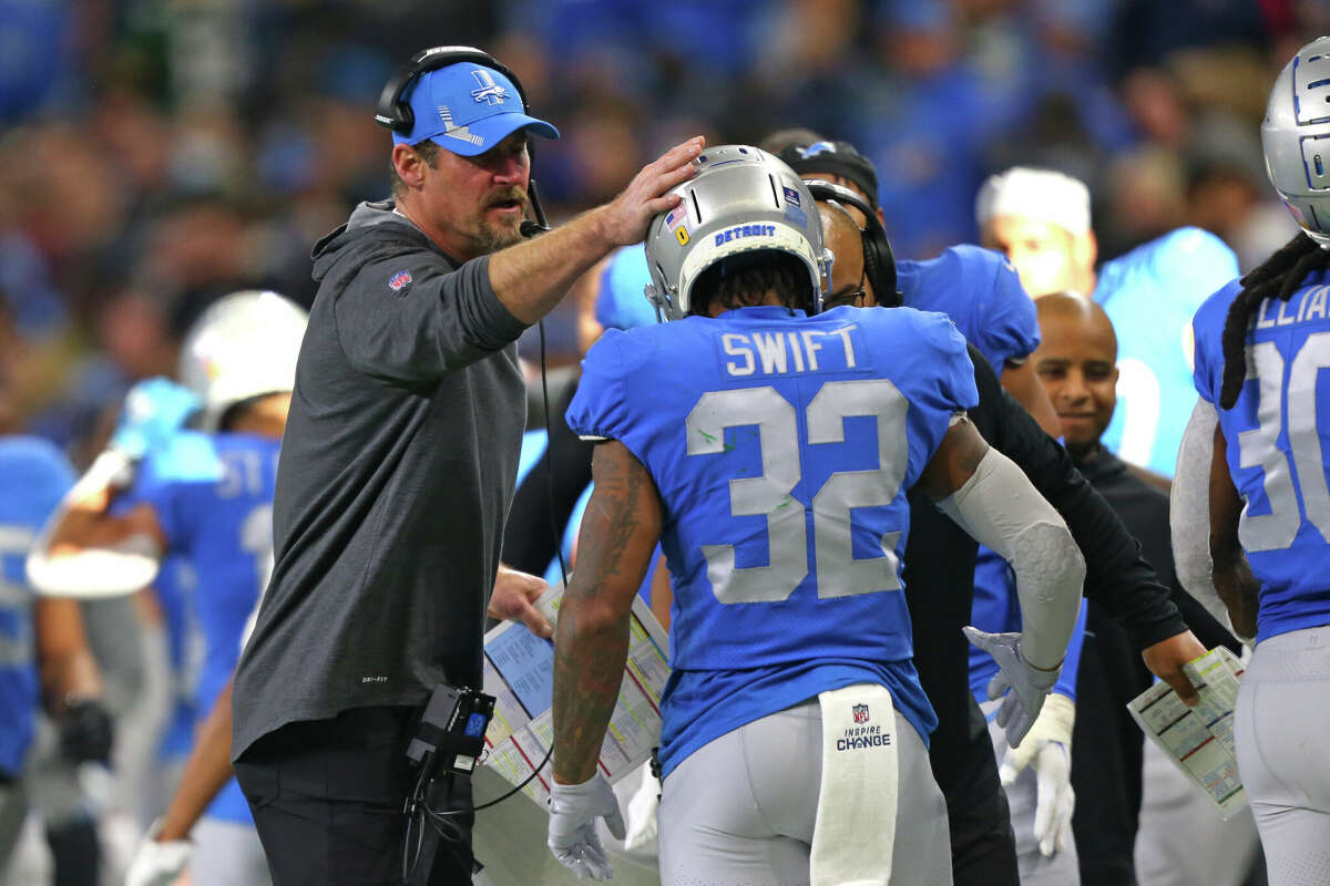 Detroit Lions running back D'Andre Swift (32) is congratulated by head coach Dan Campbell after scoring a touchdown during the second half of an NFL football game against the Green Bay Packers in Detroit, Michigan USA, on Sunday, January 9, 2022. (Photo by Jorge Lemus/NurPhoto via Getty Images)