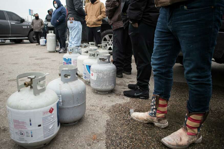 People line up to fill their empty propane tanks at a business on the North Freeway Tuesday, Feb. 16, 2021 in Houston. Temperatures stayed below freezing Tuesday, with many still without power.