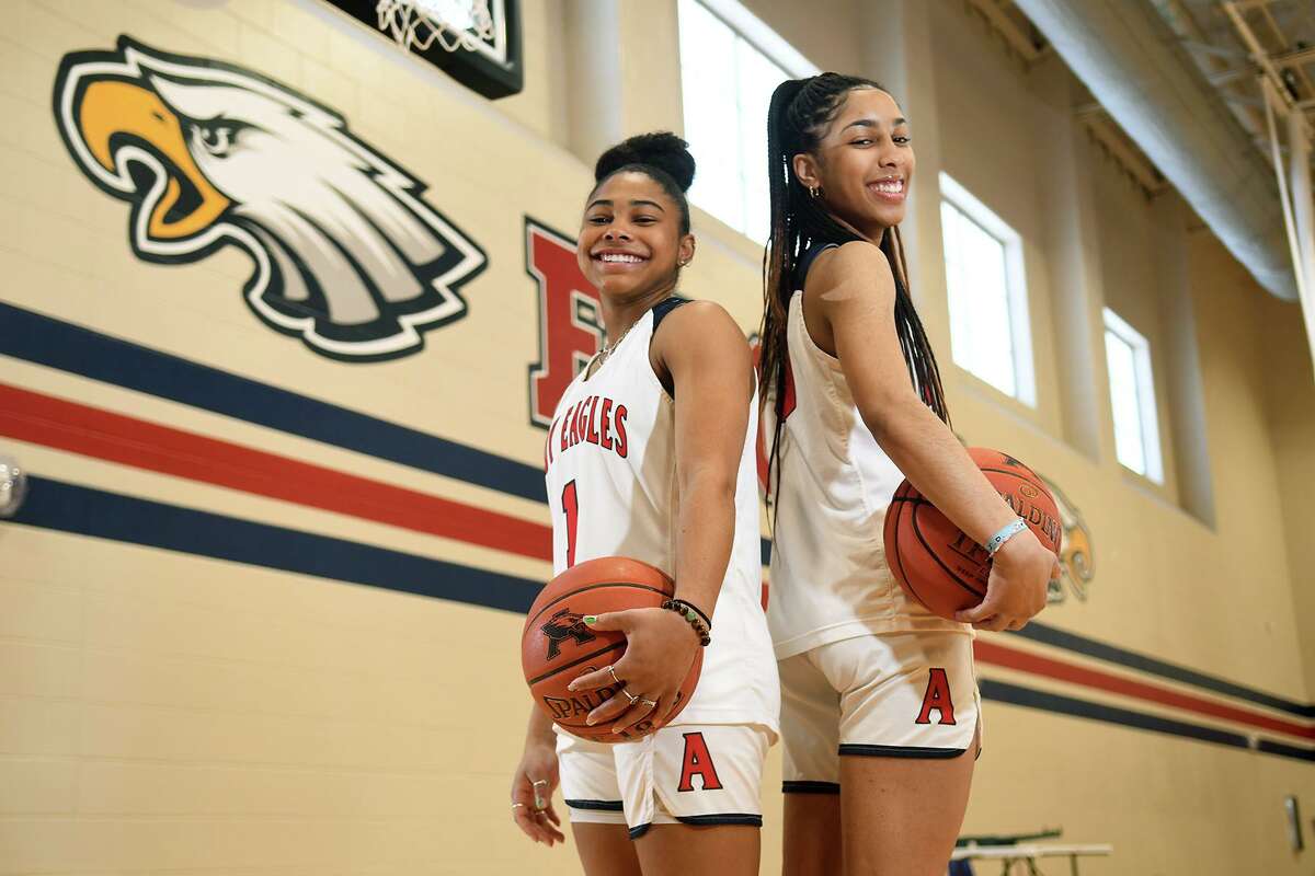 Atascocita girls basketball players Blake Matthews, left, and Kori Fenner, both seniors who will not play another game this season due to season ending injuries, pose for a photo at AHS before a team practice on Feb. 10, 2022.
