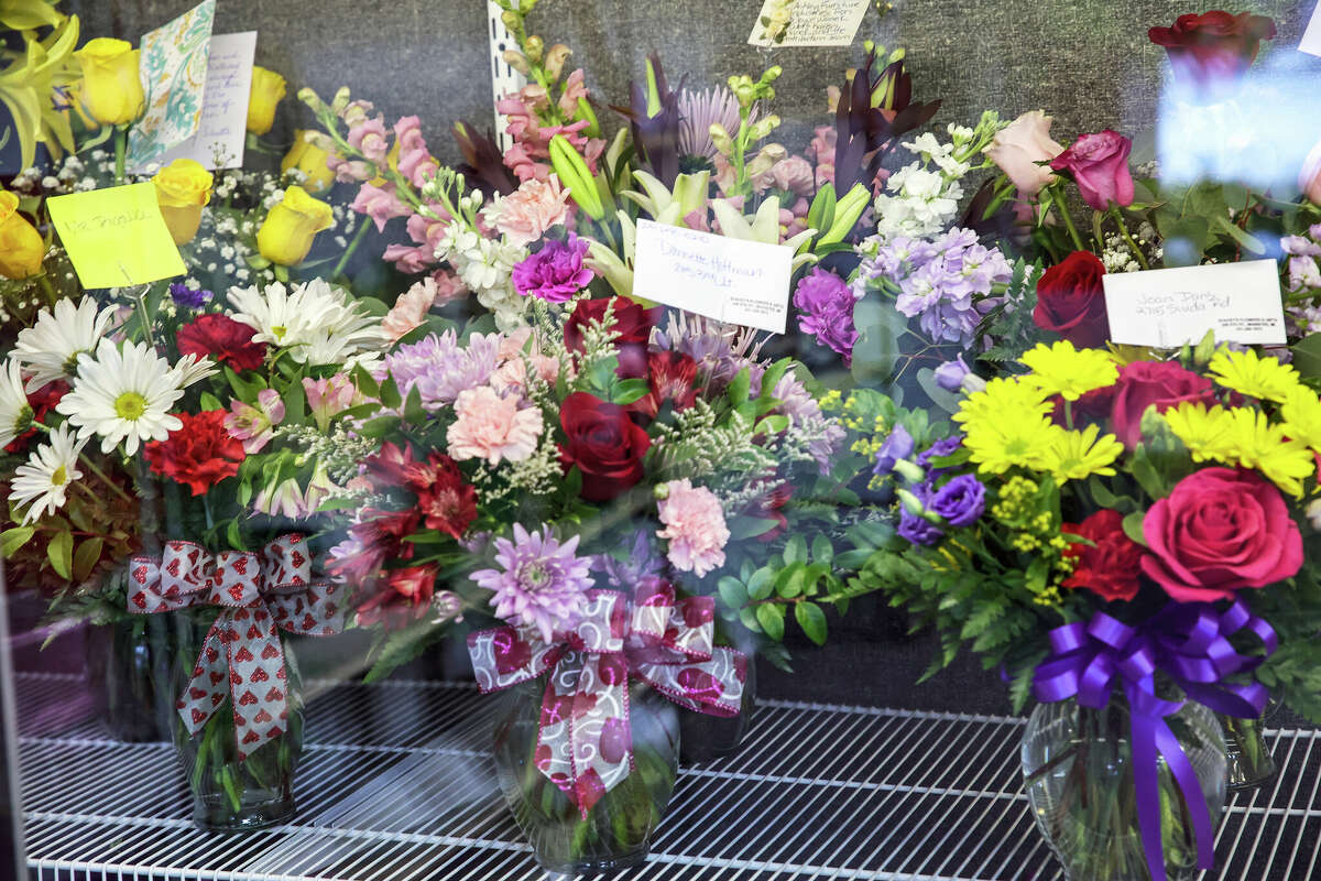 Bouquets of flowers lie inside a floral display refridgerator at Stacey's Flower and Gifts in Manistee. Mixed arrangements are the most popular items