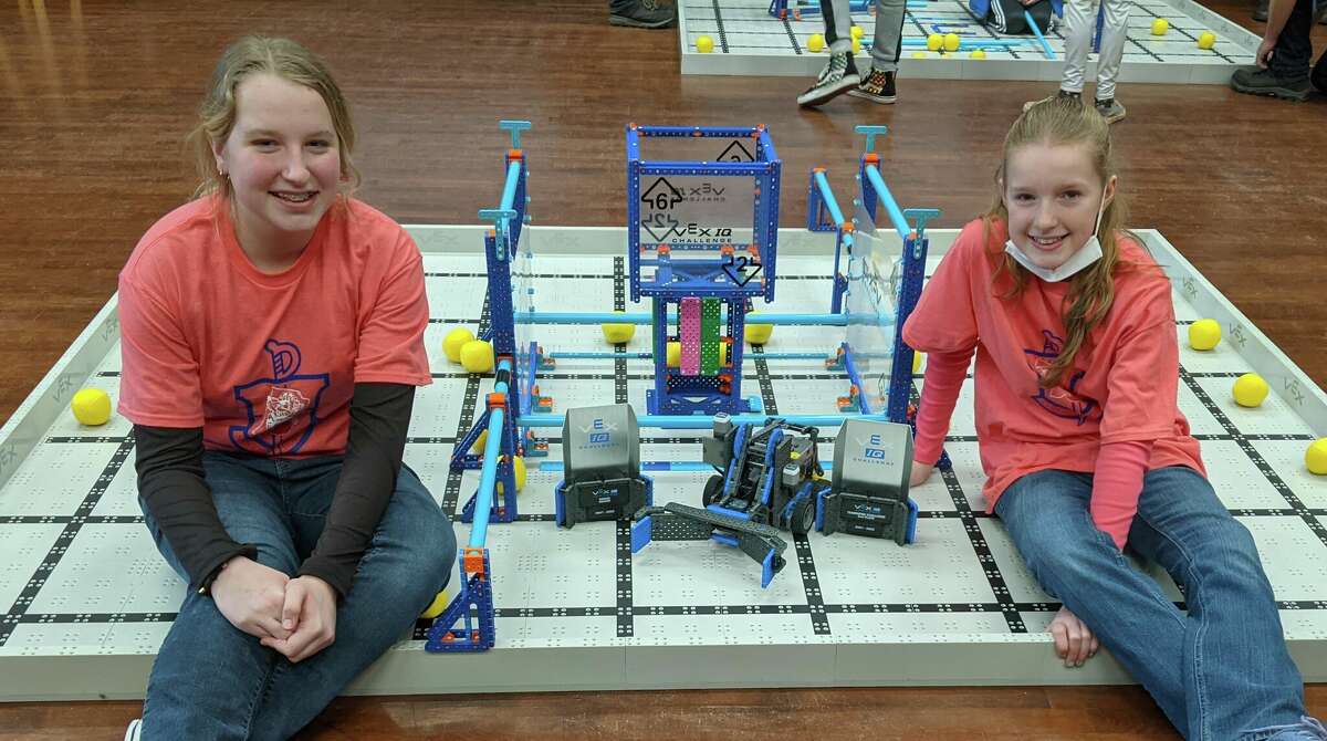 Sophia Schaub (left) and Cheyenne Martin, Manistee Catholic Central robotics team members, pose for a photo with their Amaze Award and second place Team Challenge trophy.