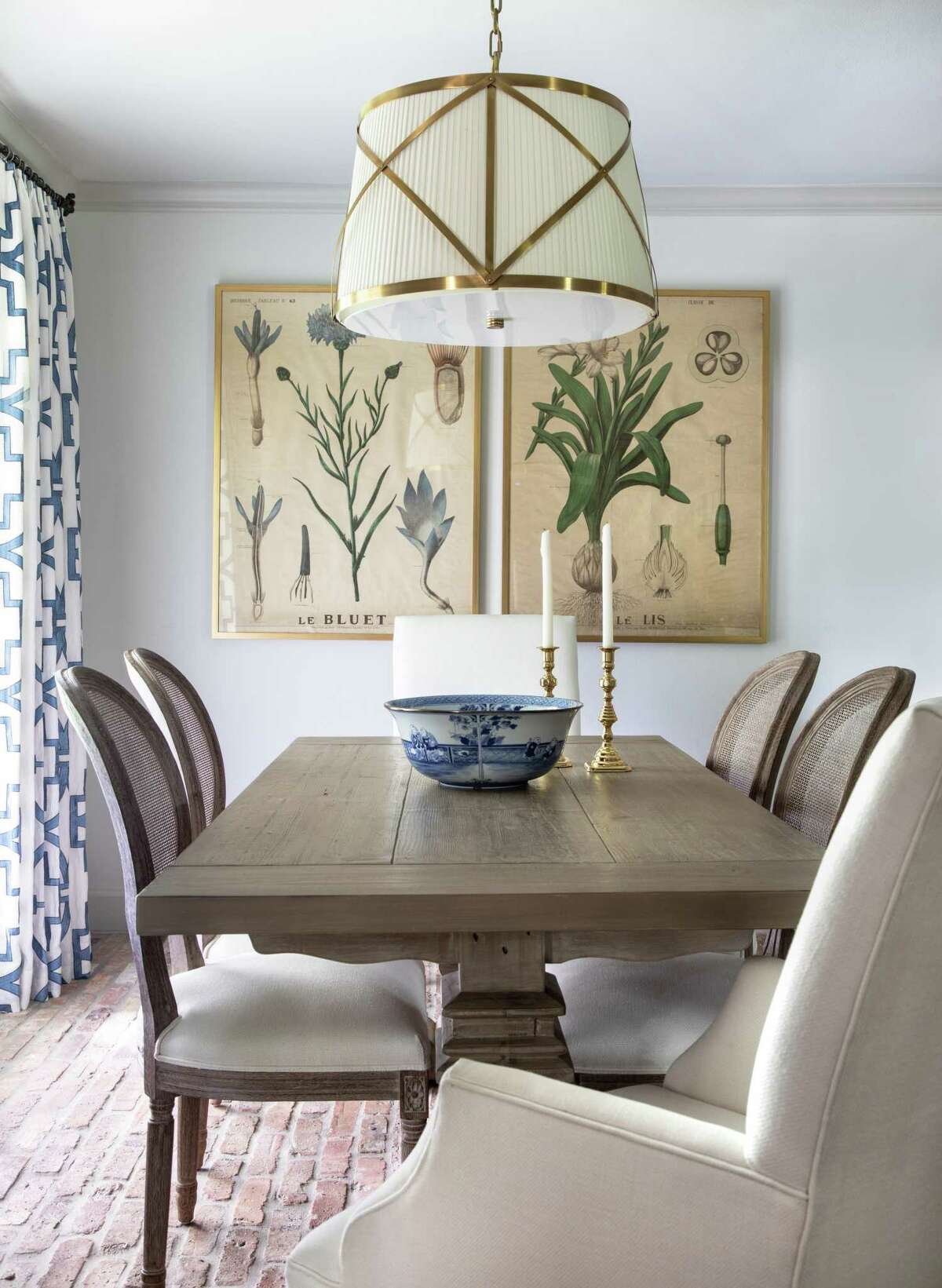 The casual breakfast area has blue-and-white print draperies. The fabric repeats in the kitchen window shade.