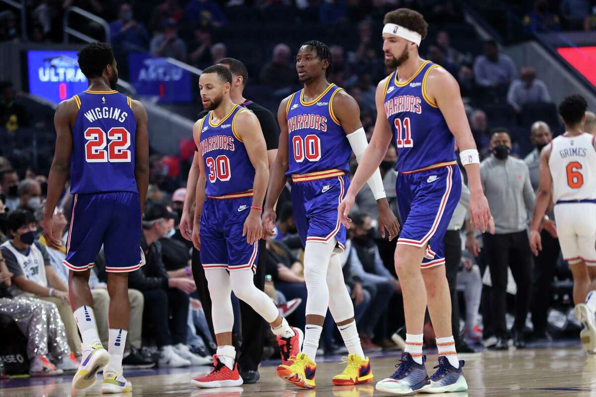 Golden State Warriors' Klay Thompson, Jonathan Kuminga, Stephen Curry and Andrew Wiggins during a 1st quarter time out while playing New York Knicks during NBA game at Chase Center in San Francisco, Calif., on Thursday, February 10, 2022.