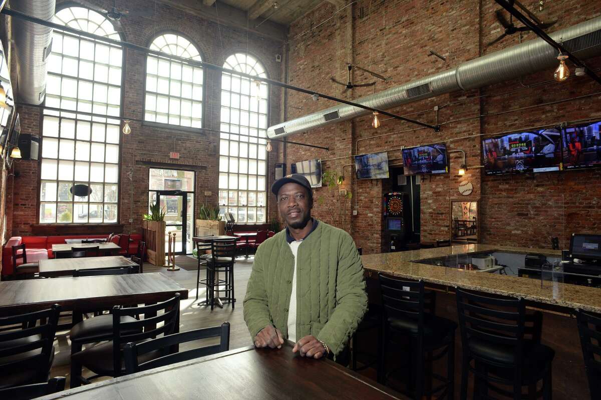 Owner Michael White poses at Bank Sports Bar, in Bridgeport, Conn. Feb. 10, 2022.