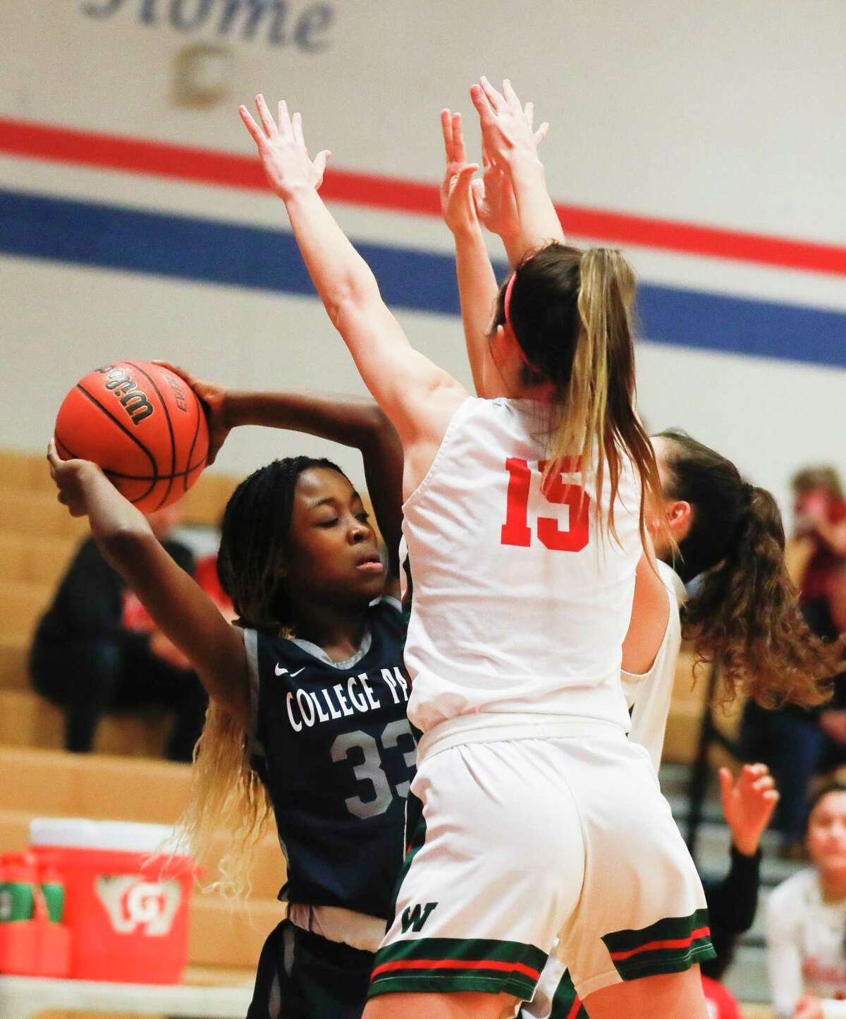 College Park power forward Natalie Ibizugbe (33) is pressured into a turnover during the first quarter of a tie-breaker high school basketball game at Oak Ridge High School, Friday, Feb. 11, 2022.