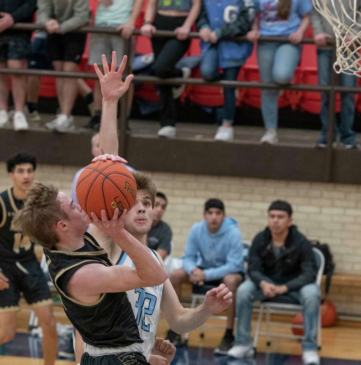 Andrews' Jerod Cargill tries to put up a shot as Greenwood's Colton Callicoatte tries to block it 02/11/2022 at Greenwood High gym. Tim Fischer/Reporter-Telegram