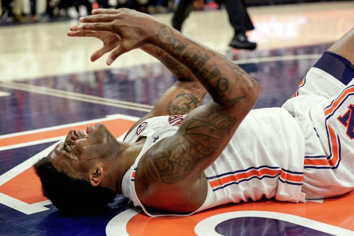 Auburn guard K.D. Johnson (0) reacts after a called foul during the first half of an NCAA college basketball game against Texas A&M, Saturday, Feb. 12, 2022, in Auburn, Ala. (AP Photo/Butch Dill)
